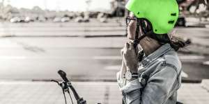 Woman putting her helmet.