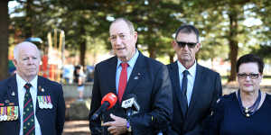 Senator Fraser Anning,centre,is joined by candidate for the seat of Cook Peter Kelly,left,as he speaks to the media at Dunningham Park at Cronulla in Sydney on Friday.