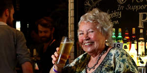 Merle Thornton,who chained herself to the bar at Brisbane’s Regatta Hotel in 1965,poses with a pint of beer at the same bar 50 years on in 2015.