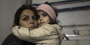 A girl embraces a family member in a shelter during shelling in Stepanakert,Nagorno-Karabakh.