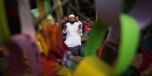 Mufti Zeeyad Ravat from Melbourne leads the crowd in a prayer near the Al Noor Mosque in Christchurch. 