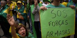 A supporter of outgoing President Jair Bolsonaro prays during a protest against his defeat in the country’s presidential runoff,outside a military base in Sao Paulo,Brazil,on Saturday.