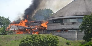 A building burns next to the Parliament building in Honiara on Wednesday.