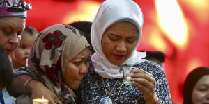 Norazlinda Ayub,left,and Intan Maizura Othaman,wife of an air crew member of MH370 at the Day of Remembrance event in Kuala Lumpur.