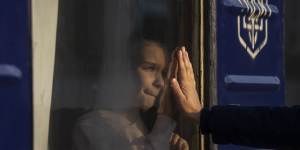 Russian Mishanin,right,bids farewell to his nine year old daughter as the train leaves with his family for Poland,at the train station in Odesa,on Monday,April 4,2022. More than 4 million people have fled the war in Ukraine and crossed borders into neighbourhood countries. (AP Photo/Petros Giannakouris)