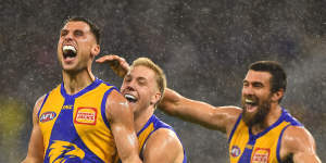 Singing in the rain:Nic Read celebrates a goal on debut for the Eagles amid a brief downpour at Optus Stadium in Perth.