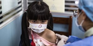 A child receives a vaccine against COVID-19 at a vaccination site on November 18,2021 in Wuhan,China.