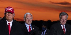 Mark Meadows,pictured on the right,is seen with Trump and Mike Pence at a campaign rally on November 2.