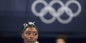Simone Biles watches on after her shock exit from the team final.