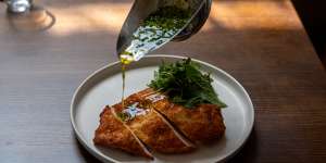 Chicken Kyiv,a crumbed schnitzel that comes with a jug of garlicky,herb-flecked butter.