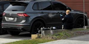 NSW police collect evidence at 31 Mary Wade Place in Carnes Hill which is now a crime scene after a 25 year old male was shot twice during a targeted home invasion by eight masked people. A vehicle in the driveway was also damaged. 