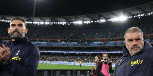Tottenham Hotspur coach Ange Postecoglou,right,and former Socceroos captain Mile Jedinak thanks fans at the MCG on Wednesday night.