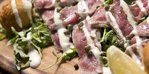 Il Locale's vitello tonnato,poached veal with potato and tuna fritters.