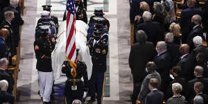 A military bearer team carries the casket after the funeral for former Secretary of State Colin Powell. 