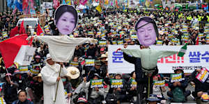 Members of the national federation of farmers,known as “Junnong”,and the Korean Confederation of Trade Unions,with effigies of South Korean President Yoon Suk Yeol (right) and his wife,Kim Keon-hee.