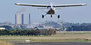 A Gippsaero GA8 Airvan taking off with the (since-demolished) Hazelwood power plant in the background.
