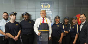  Donald Trump poses with employees during a visit to McDonald’s.