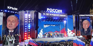 Russian President Vladimir Putin is displayed on huge screens at a Red Square concert marking his election win and the 10-year anniversary of Crimea.