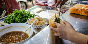 Tasting banh mi in Hanoi old town.