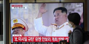 A TV screen showing a news program reporting about North Korea’s missile launch with file footage of North Korean leader Kim Jong Un,is seen at the Seoul Railway Station in Seoul.