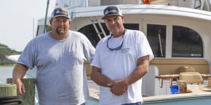 From left,Sensation boat owner Ashley Bleau and captain Greg McCoy stand on the dock in Morehead City,North Carolina,on June 30,2023. 
