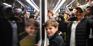 Adam Riakos travels with his grandfather Mosh Riakos on the first paid passenger Metro train on the M1 line from Sydenham station to Chatswood.