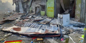 Debris lies on the street outside damaged shops in Chinatown,Honiara,Solomon Islands,on Friday.