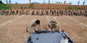 Two YPG fighters teach new conscripts to Rojava's new army how to dismantle and reassemble a heavy machine gun known as a dushka. 