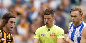 Umpire Michael Pell officiates during the round one AFL match between Hawthorn and North Melbourne at the MCG on March 20.