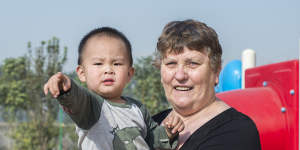 Linda Shum,65,holds Zheng Yue,2,near outside play equipment at Eagles’ Wings,an aid organisation founded by Shum and her late husband Greg to help abandoned,disabled and orphaned children in partnership with Chinese welfare authorities. 