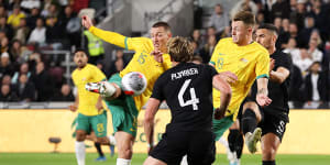 Mitch Duke unleashes the strike which led to Australia’s opening goal,ultimately awarded to Harry Souttar (right).