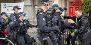 Victoria Police scuffle with anti-vaccine protesters in Victoria Street in North Melbourne for breaching the Chief Health Officer’s lockdown directives.