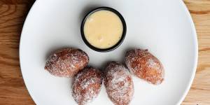 Yeasty,sugar-coated zeppole doughnut balls with vanilla custard.