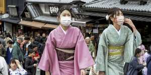 Don’t bother the Geishas. Visitors walk along a sightseeing destination in Kyoto,Japan.