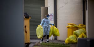 A worker disposes of hazardous waste during a deep clean at St Basil's on July 28. 
