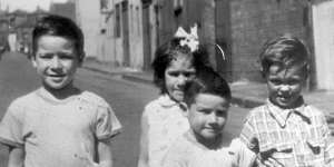 Tony Birch,7,in the foreground,in Fitzroy in 1965. Behind are his brother,Brian (left),his sister,Deborah (centre) and a friend,Jimmy.