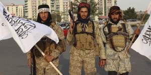 Taliban fighters hold flags in Kabul,Afghanistan.