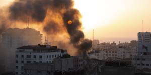 Smoke is seen from a collapsed building after it was hit by Israeli airstrikes on Gaza City.