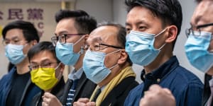 Pro-democracy activists gesture during a press conference on January 6 in Hong Kong after 50 opposition figures were arrested under the national security law.