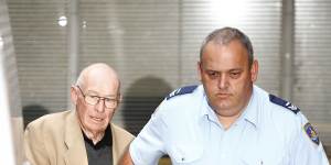 Roger Rogerson is escorted out of court during his trial for murder in 2016.