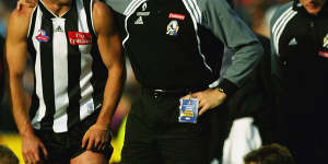 Paul Licuria and Mick Malthouse in the aftermath of the 2002 grand final,which Collingwood lost narrowly.