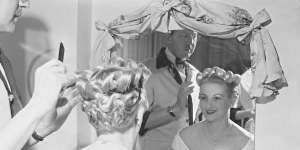 A stylist plants the final touches on a"coronation hairstyle"at a Kings Cross salon in June 1953. 