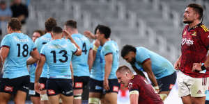 Highlanders players are shattered as the Waratahs celebrate the win.