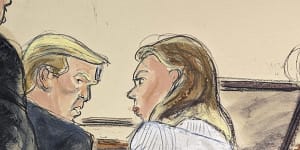 Trump advisor Boris Epshteyn,foreground left,leans over Donald Trump to confer with him and lead defence attorney Alina Habba,right,prior to jury selection in Federal Court,in New York. 