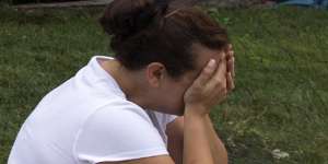 Connie Leon,16,cries outside her flood-damaged home as a clean-up effort starts in the north-eastern US.