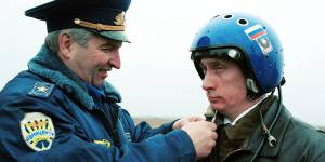 Russian air force general Alexander Kharchevsky adjusts a helmet on Vladimir Putin,then Russia’s Acting President,before he flew into Chechnya in a fighter jet on March 20,2000. 
