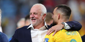 Socceroos coach Graham Arnold celebrates with Bailey Wright after beating Denmark in Qatar.