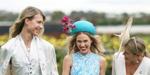Whatever the weather ... Crystal Kimber-Peters (centre) with fellow VRC ambassadors Christian Wilkins and Rebecca Share at Flemington on Monday.