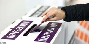 A person casts their referendum vote during election day on October 17.