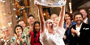 Laura Sharrad lifts the MasterChef Australia trophy after winning on her third attempt on the show. 